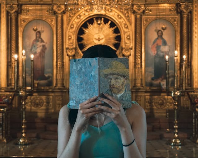 Woman Holding a Book in Front of Her Face in Church